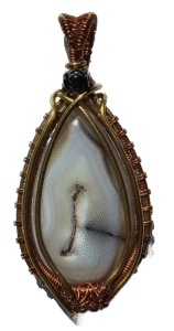 A stone pendant in a woven copper wire setting